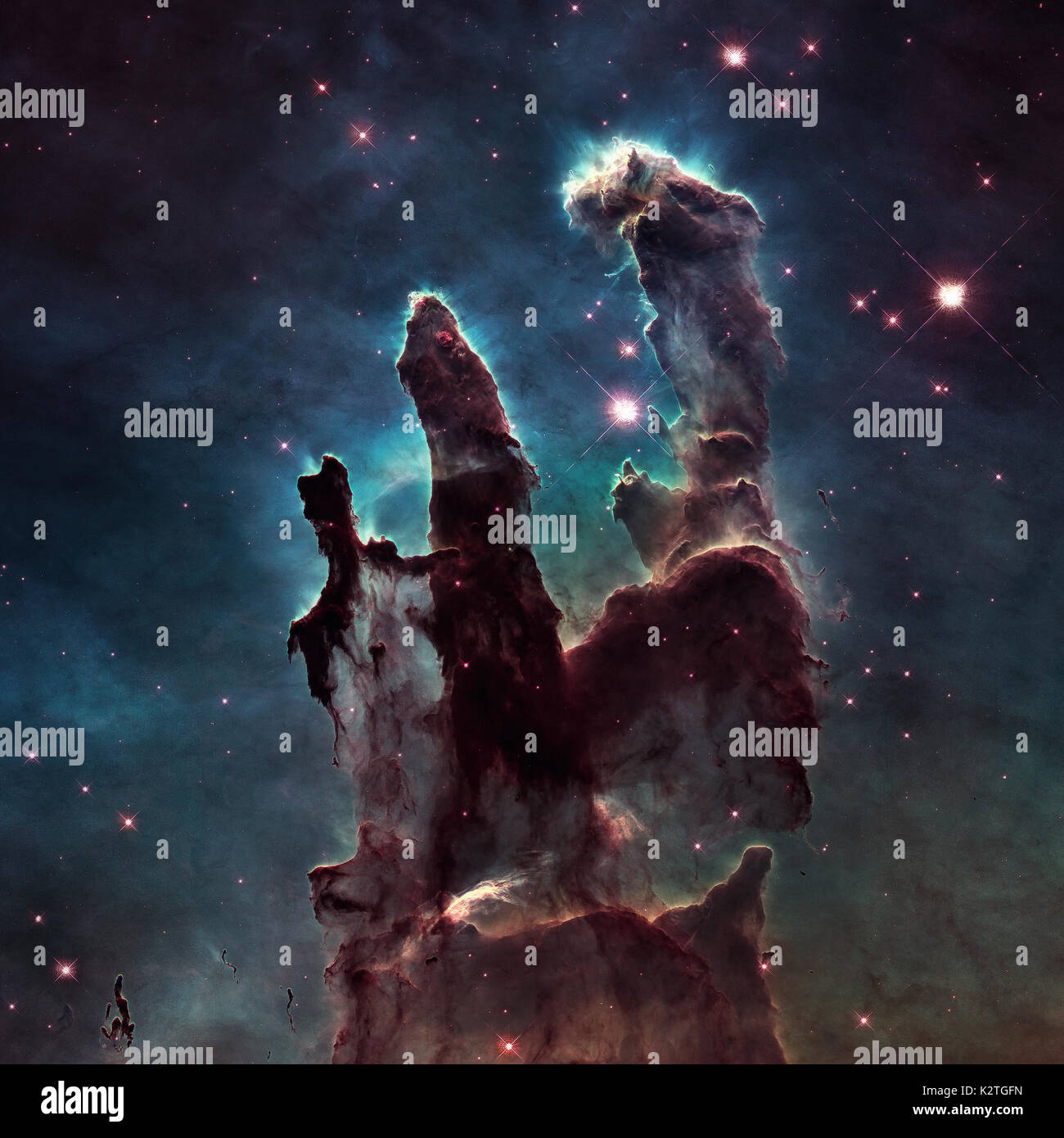 The Pillars of Creation. The Eagle Nebula or M16 or NGC 6611 is a young open cluster of stars in the constellation Serpens. Retouched image with small Stock Photo