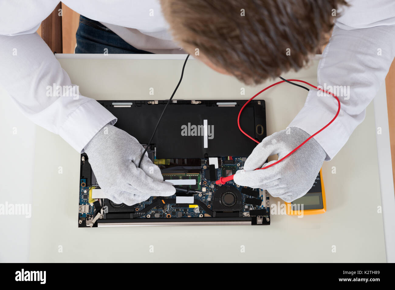 Closeup Of Person Hands Testing Laptop Motherboard Using Multimeter Stock Photo Alamy