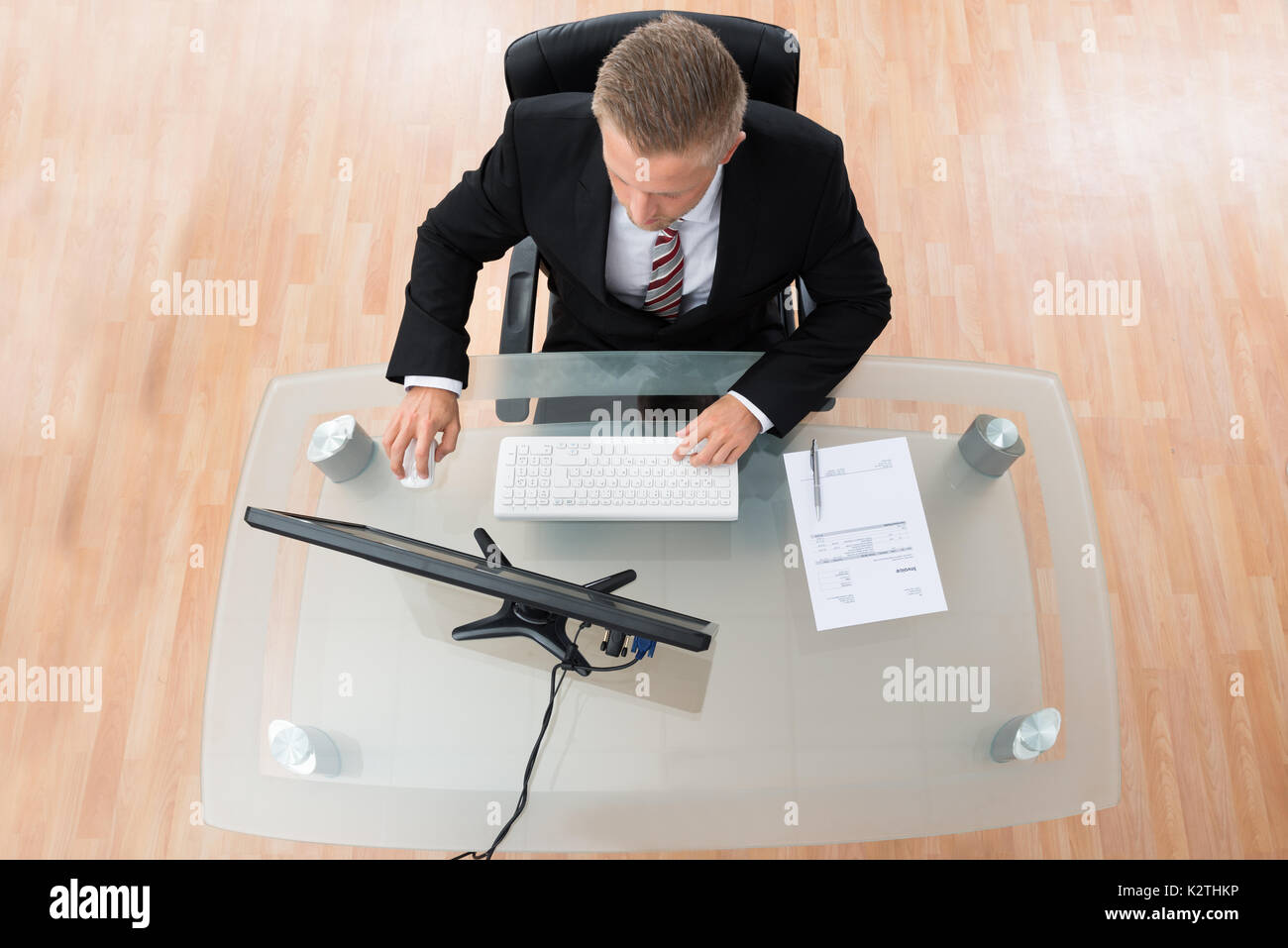 Young Businessman Working On Computer At Desk Stock Photo