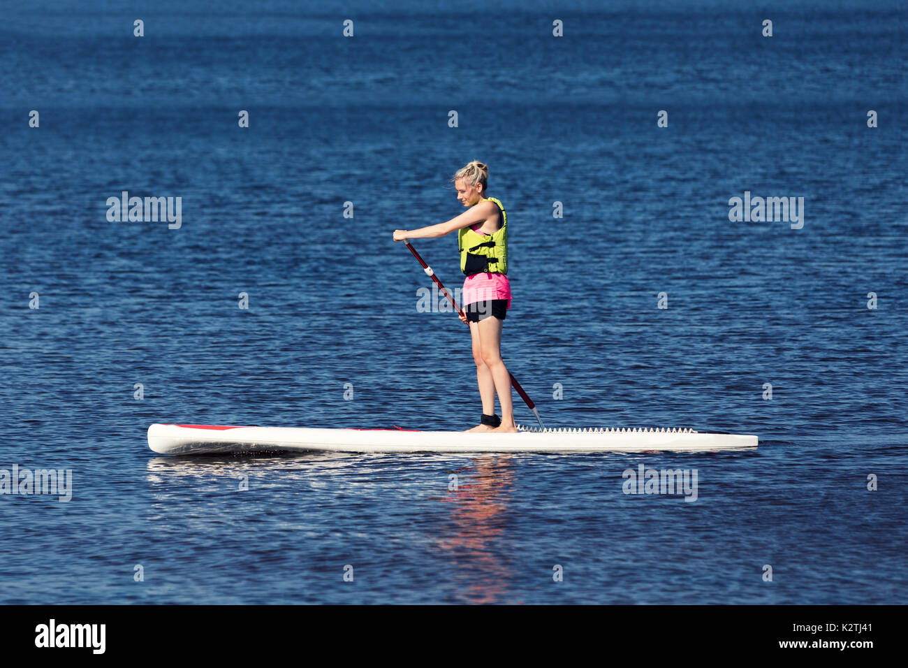 SUP fitness - woman on paddle board in the lake Stock Photo