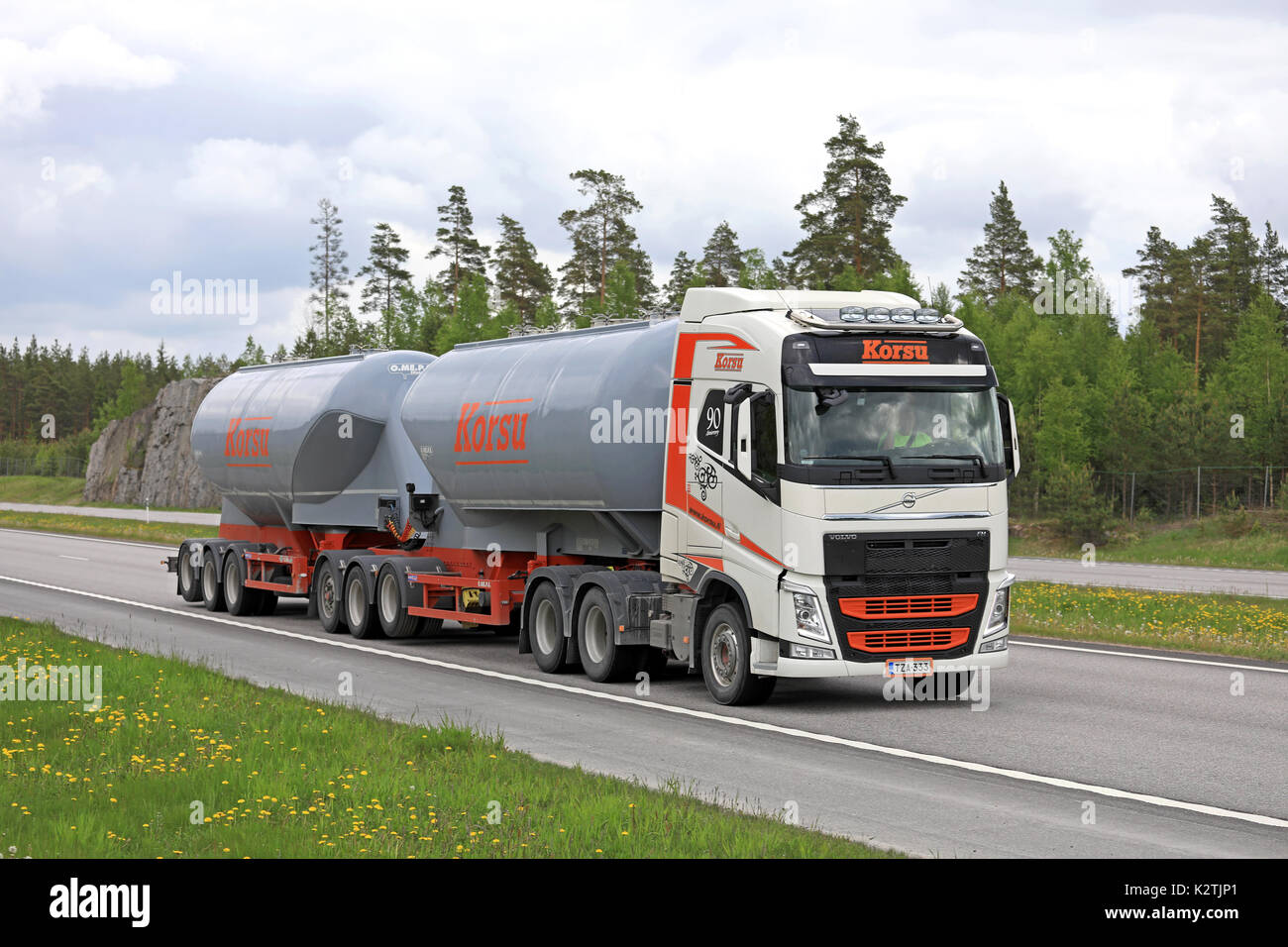 PAIMIO, FINLAND - JUNE 9, 2017: Orange and White Volvo FH tank truck of Korsu Oy moves along freeway in Finnish summer scenery. Stock Photo