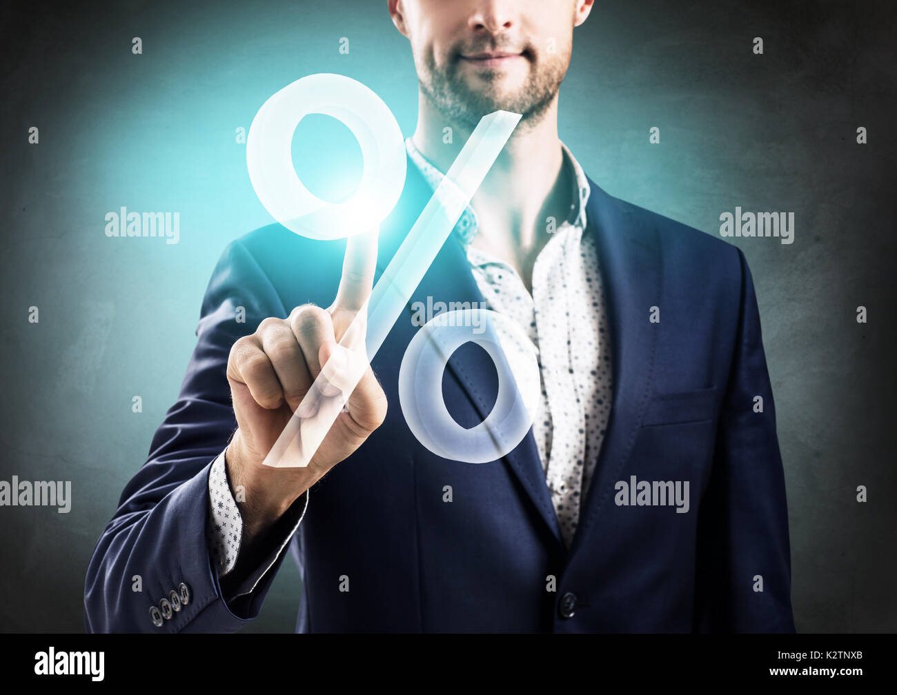Businessman pushing big virtual percent. Stock Photo