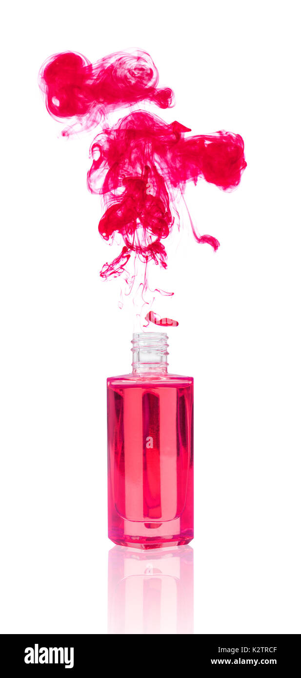 Cosmetic oil bottle with colorful explosion. Stock Photo