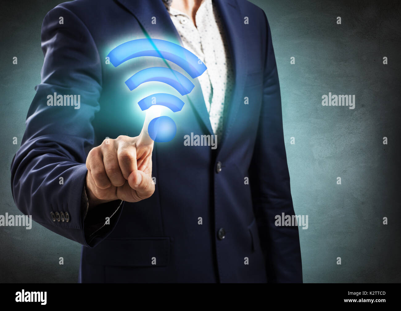Businessman touched big virtual wifi icon. Stock Photo