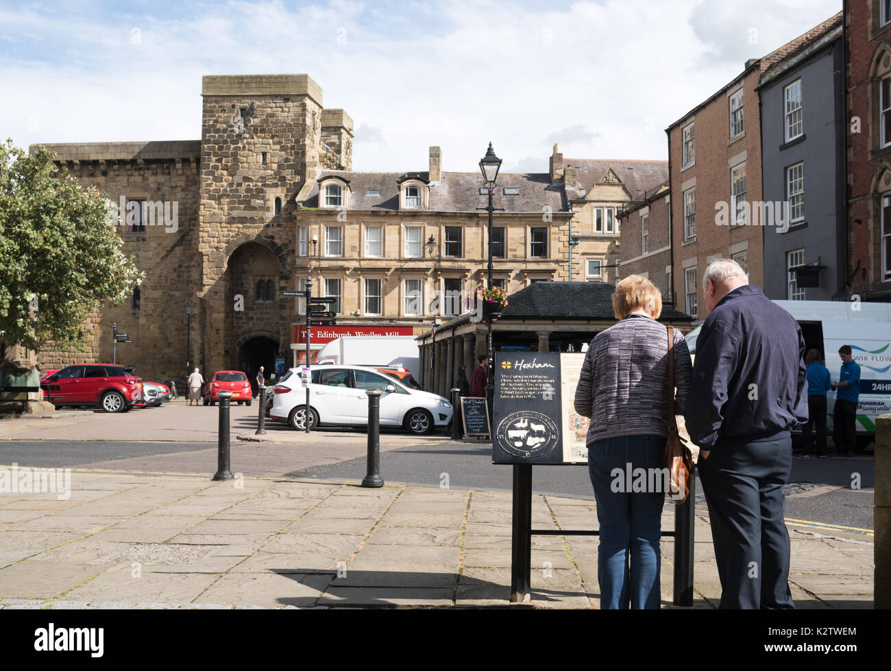 Older couple looking at town plan within the market place, Hexham, Northumberland, England, UK Stock Photo
