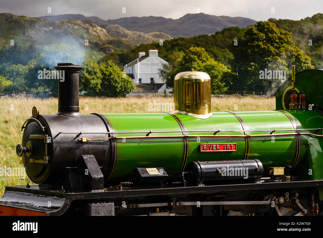 Ravensglass & Eskdale Railway steam locomotive with the Lake District fells behind Stock Photo