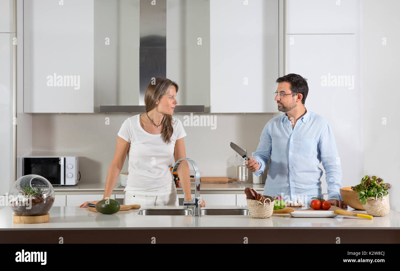 couple preparing food in a kitchen Stock Photo