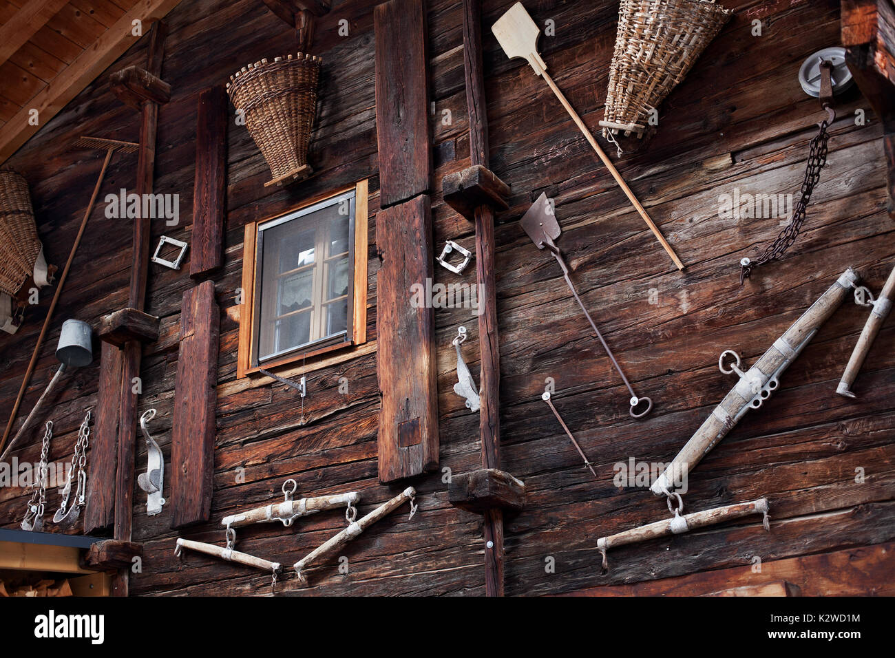 House  exterior decorated with old farming tools, Ulrichen, Switzerland. Stock Photo