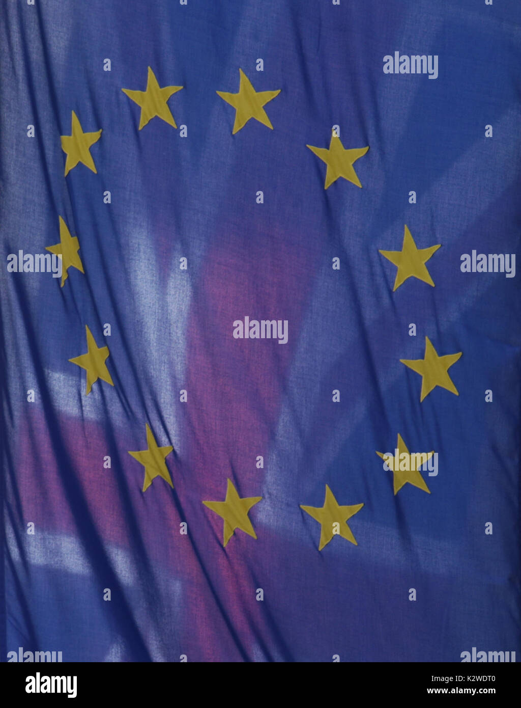 A view of the Union Jack behind the EU flag hanging outside Europe House in Smith Square, London. A row over the Brexit divorce bill has dominated the latest round of talks between the UK and the European Union, with both sides in the Brussels negotiations voicing their frustrations. Stock Photo