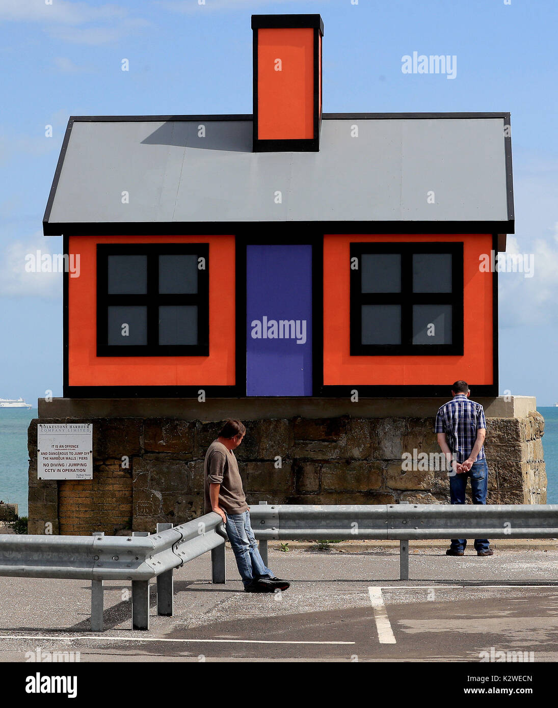 Visitors view a piece called Holiday Homes by Richard Woods, during a