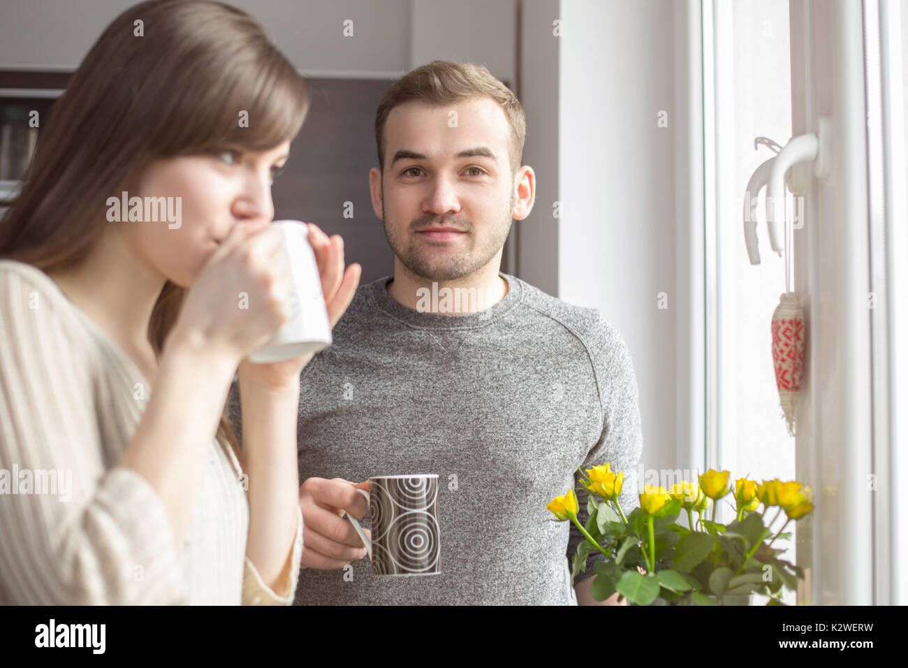 Young couple having morning coffee in kitchen Stock Photo Alamy