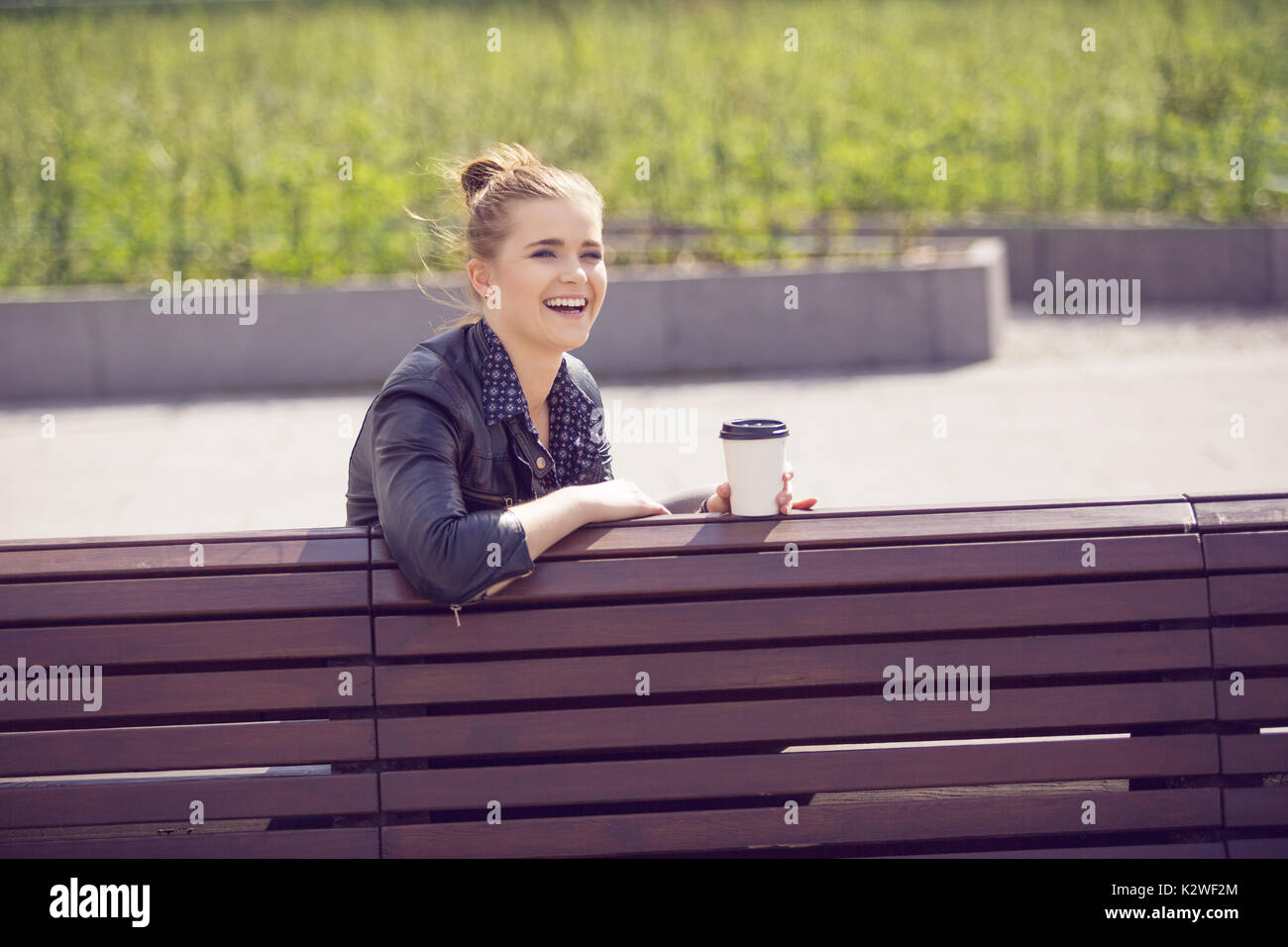 Joyful young woman having coffee break Stock Photo