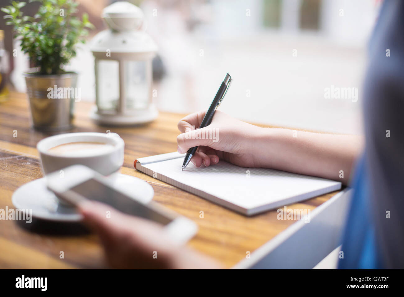 Making notes at coffee break in cafe Stock Photo Alamy