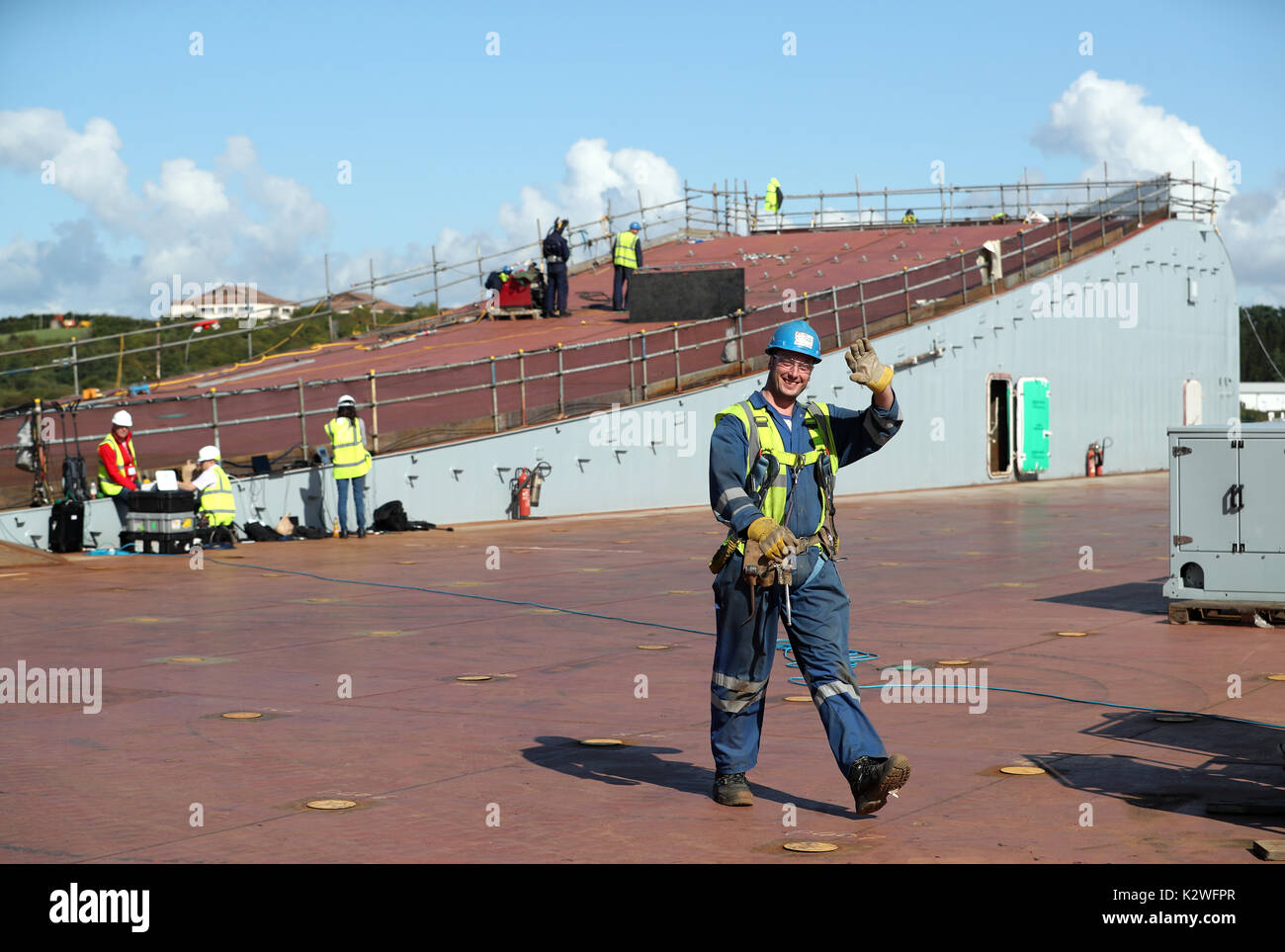 Workers on the flight deck of the HMS Prince of Wales, ahead of a naming ceremony for the aircraft carrier, in Rosyth Dockyard, Fife. Stock Photo