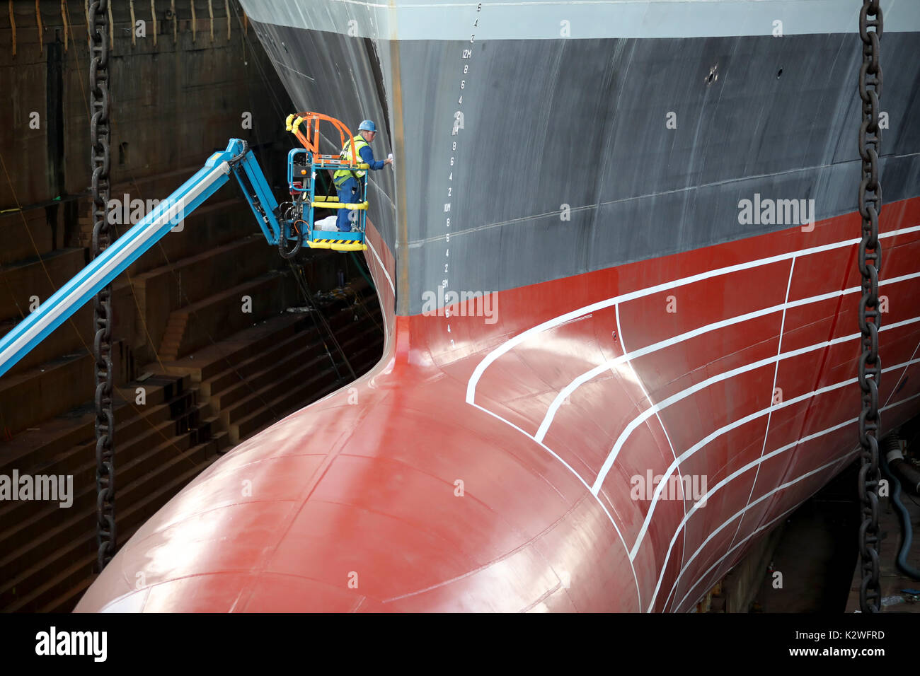 The hull of the HMS Prince of Wales is cleaned as works continue on the