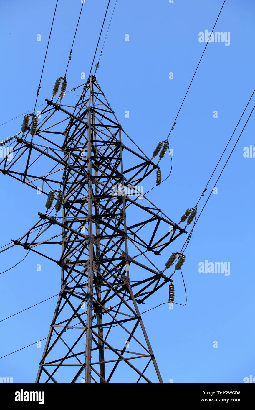 Power lines and electricity pylon against blue sky Stock Photo - Alamy