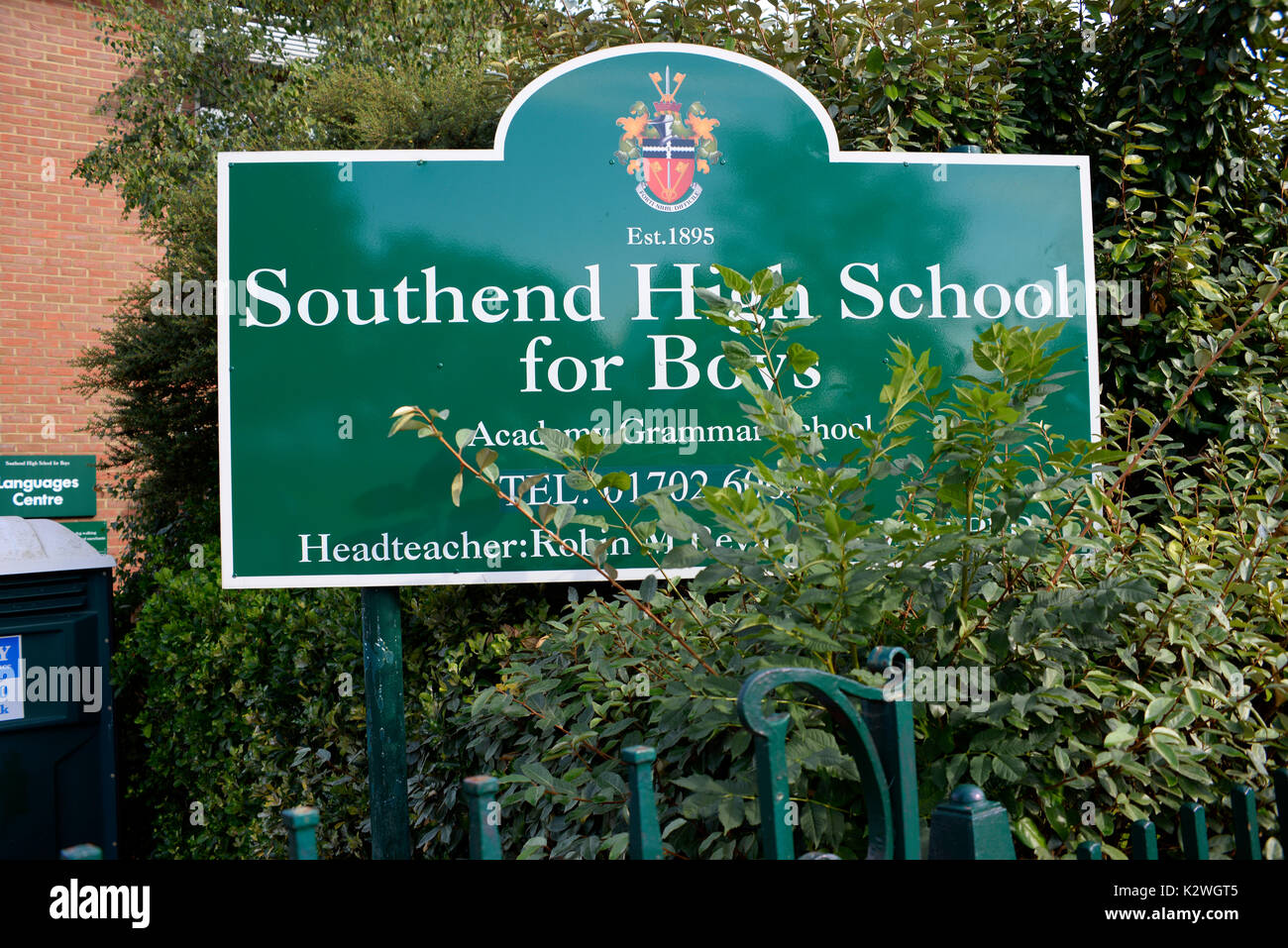 Southend High School for Boys sign with overgrowing bush. Southend on Sea, Essex Stock Photo