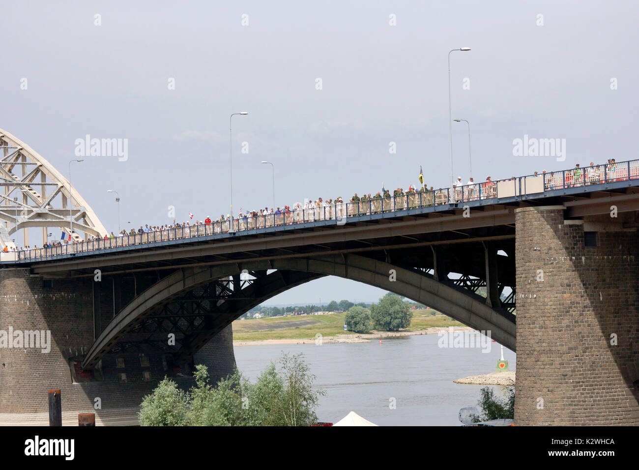 NIJMEGEN, THE NETHERLANDS – 16 JULY 2013  People from all over the world walk over de bridge in Nijmegen around 50 kilometers per day, four days long. Stock Photo