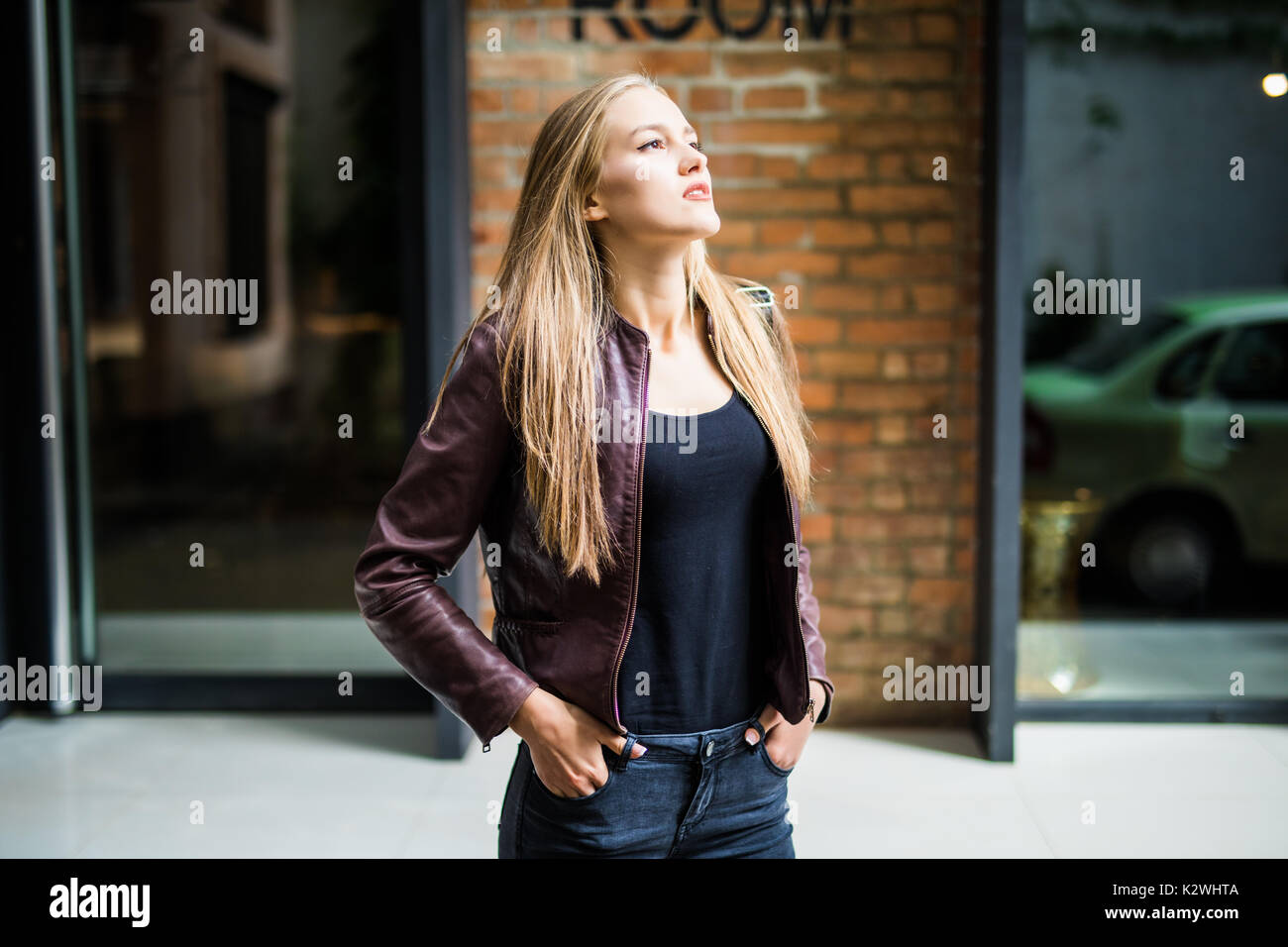 Summer sunny lifestyle fashion portrait of young stylish hipster woman walking on the street, wearing cute trendy outfit Stock Photo