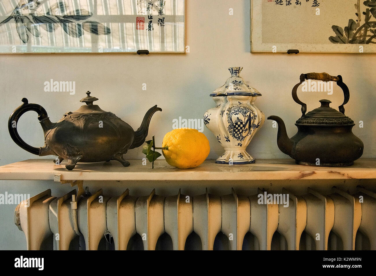 STILL LIFE PHOTO WITH LEMONS TEA POTS ON THE RADIATOR Stock Photo