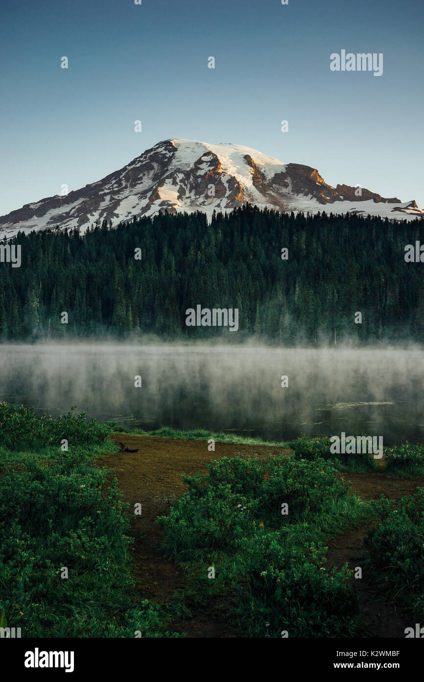 This is the picture of Mt Rainier at Reflection Lakes in the morning with fog and mist at Mt Rainier National Park. Stock Photo