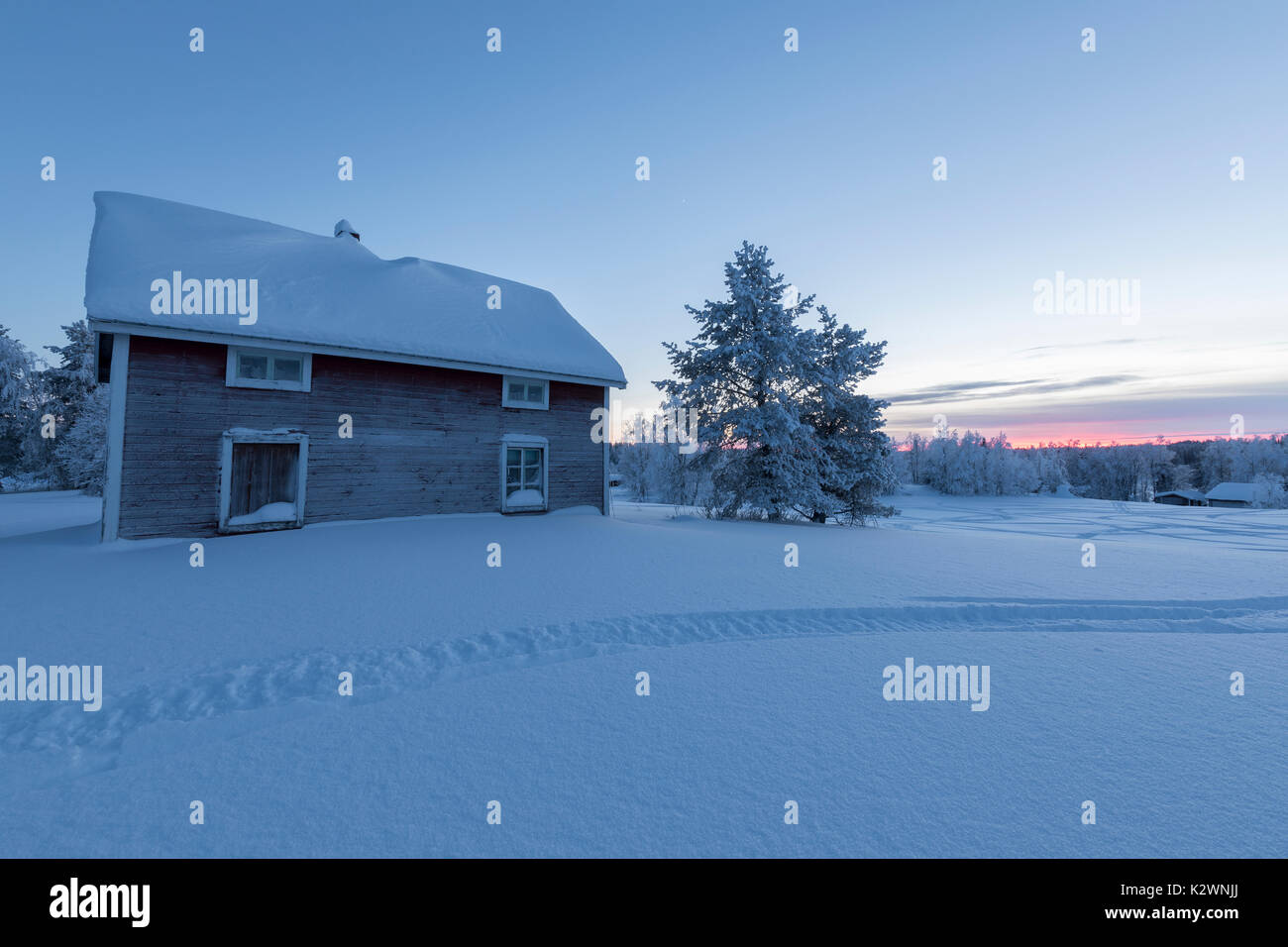 House covered with snow at dusk, Kiruna, Norrbotten County, Lapland, Sweden Stock Photo