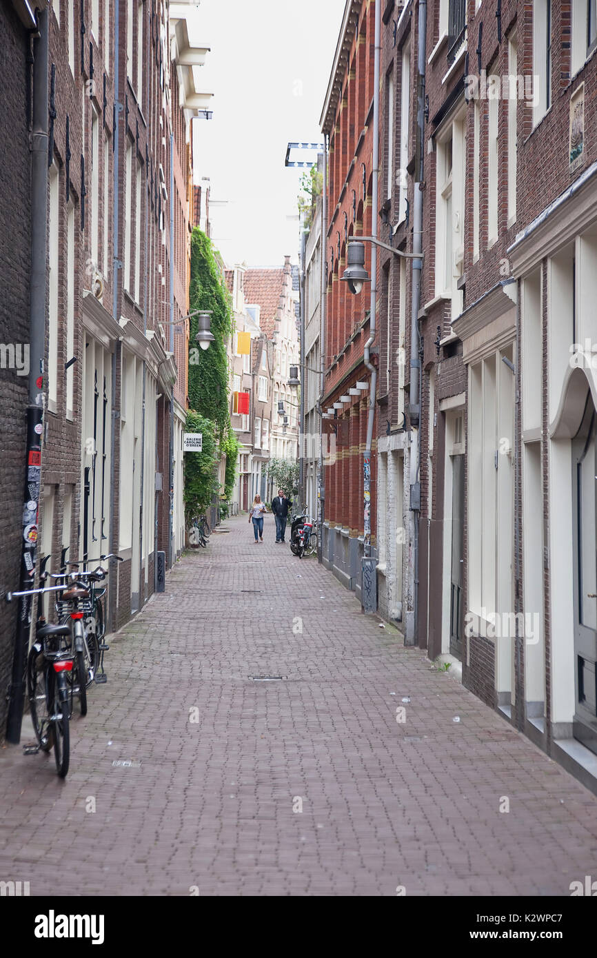 Holland, North, Amsterdam, Bicycle parked in typical narrow cobbled street. Stock Photo