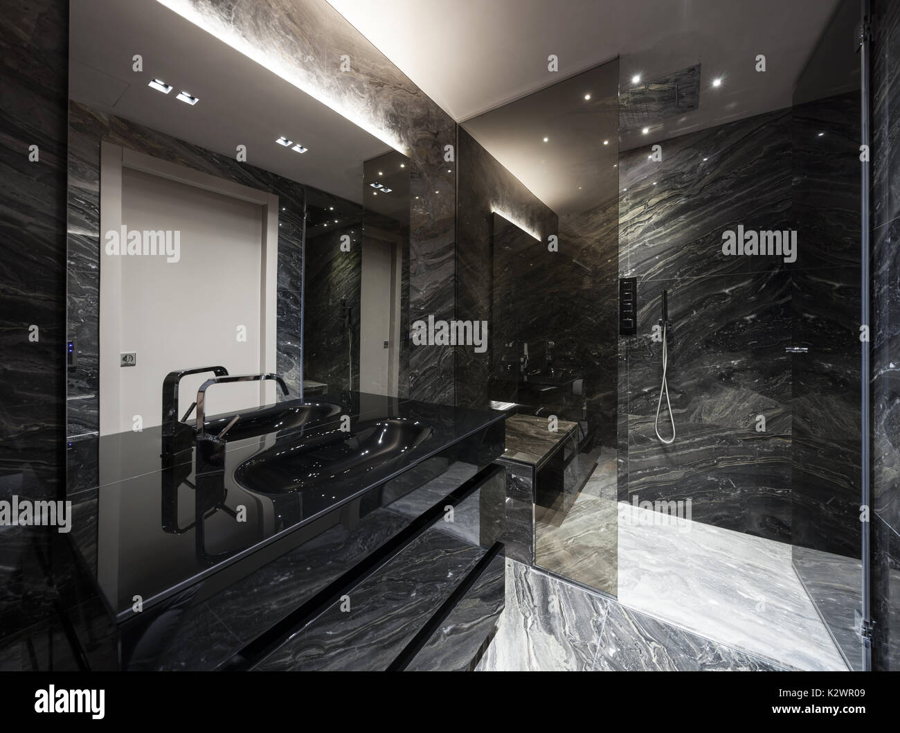 Interior of modern bathroom with black marble Stock Photo - Alamy