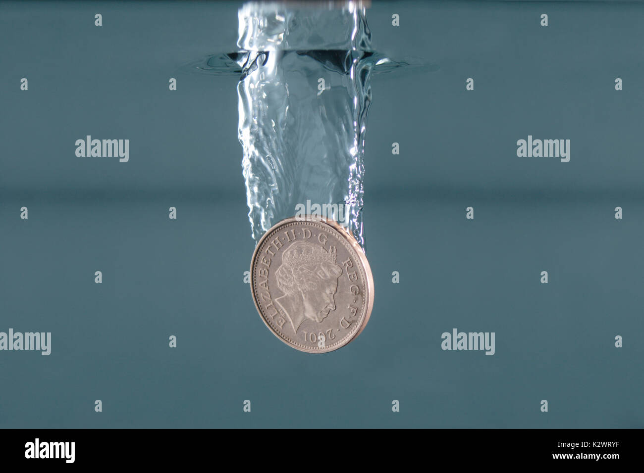 British money falling into water, photographed from below the waterline. Stock Photo