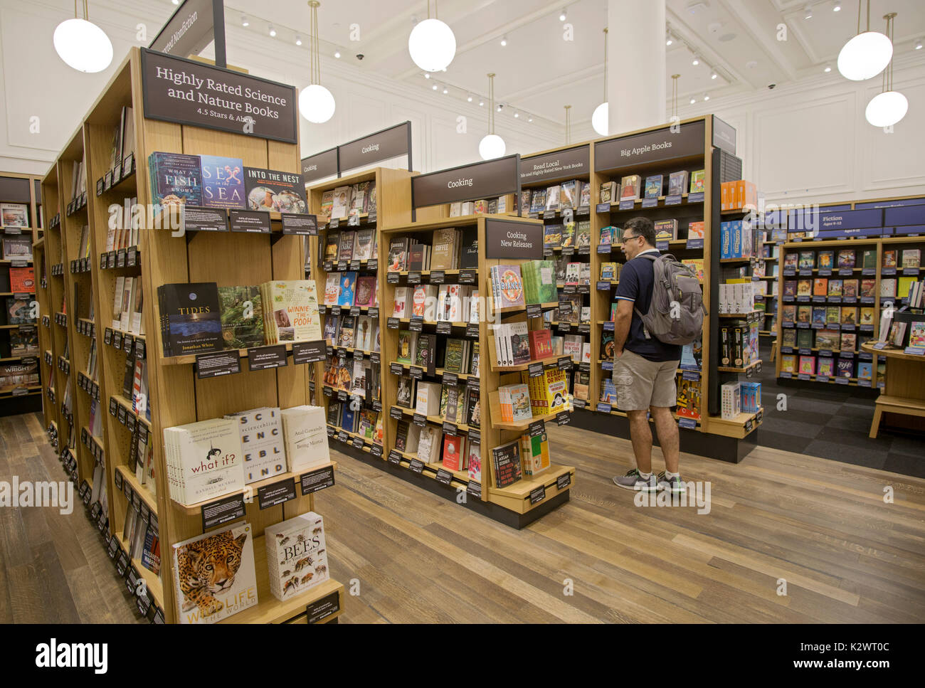 A man browsing at the recently opened Amazon Book Store on W. 34th Street in Manhattan, a rare Amazon brick & mortar store. Stock Photo