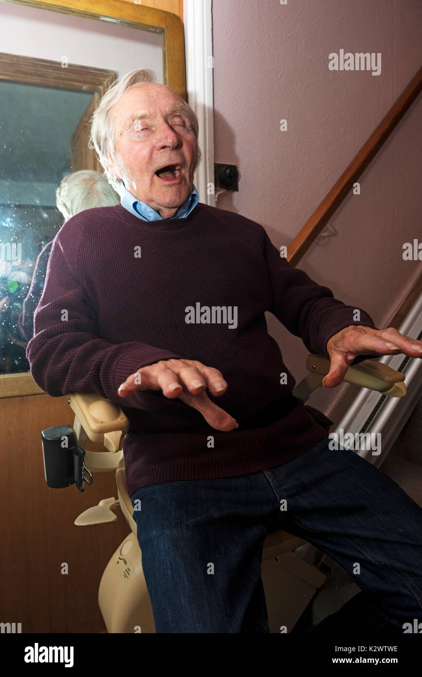 Former entertainer singing himself upstairs on a chairlift Stock Photo