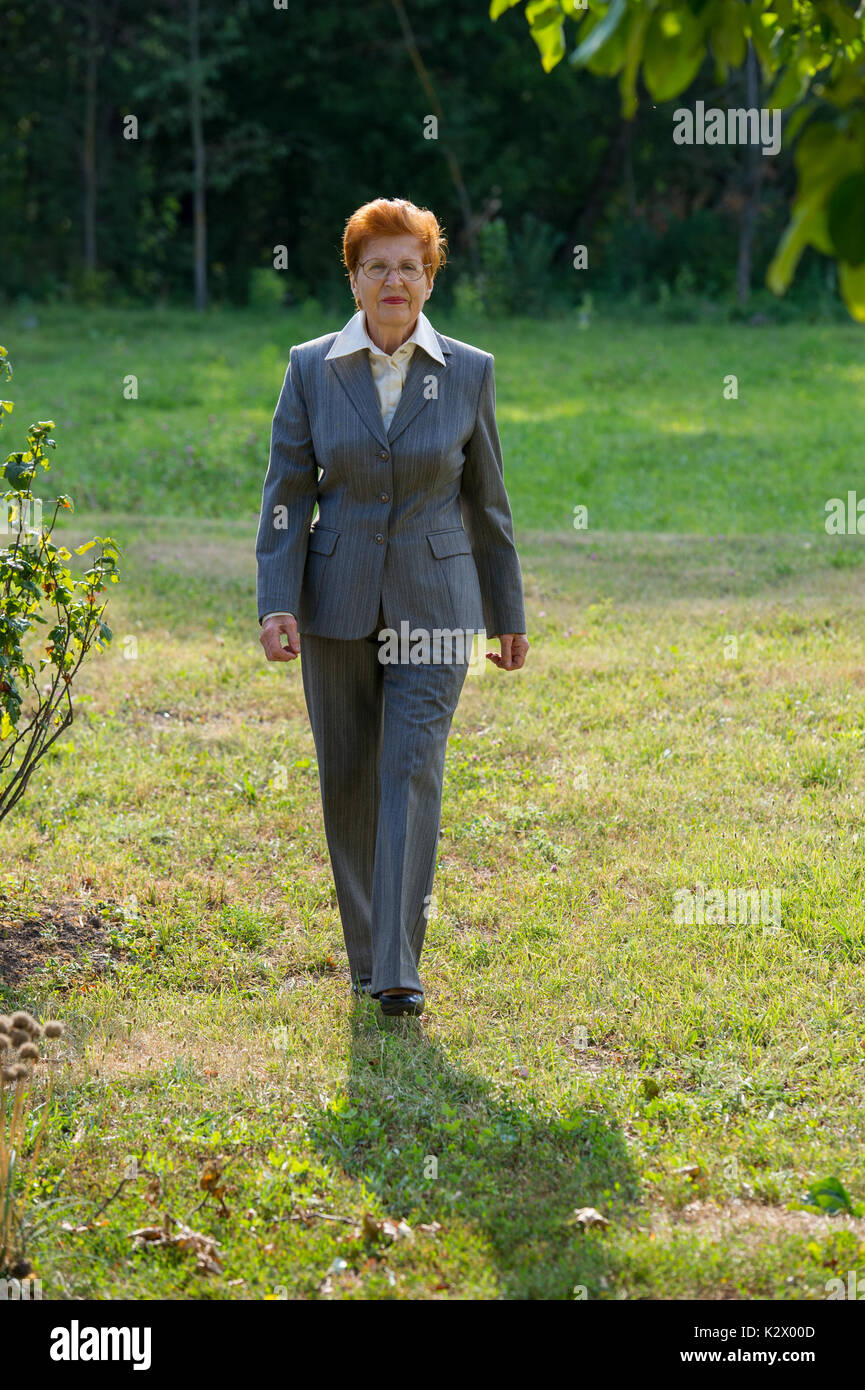 Mature elegant woman walking hi-res stock photography and images - Alamy