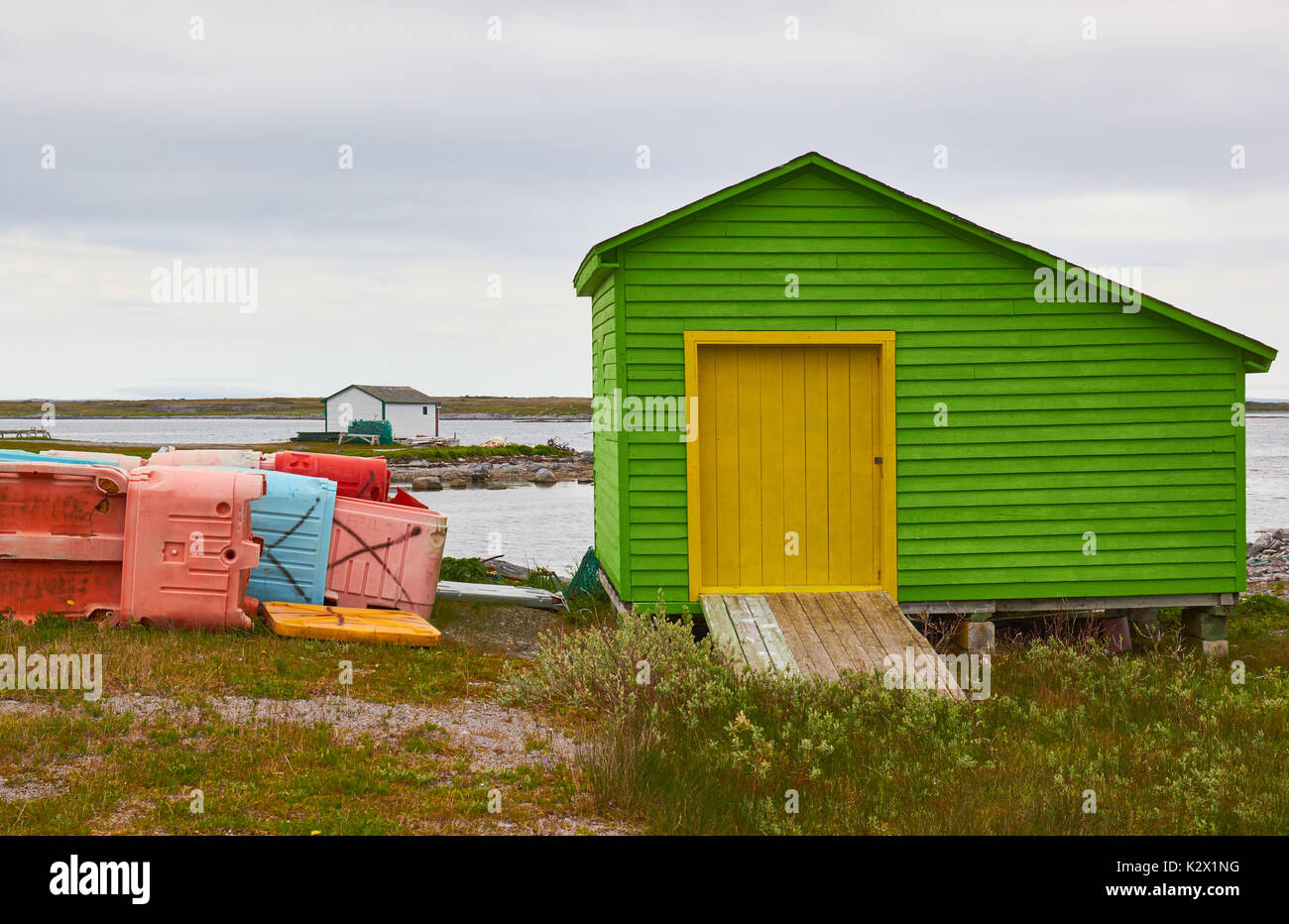 Green timber cabin and fish storage boxes, Great Northern Peninsula, Newfoundland, Canada Stock Photo