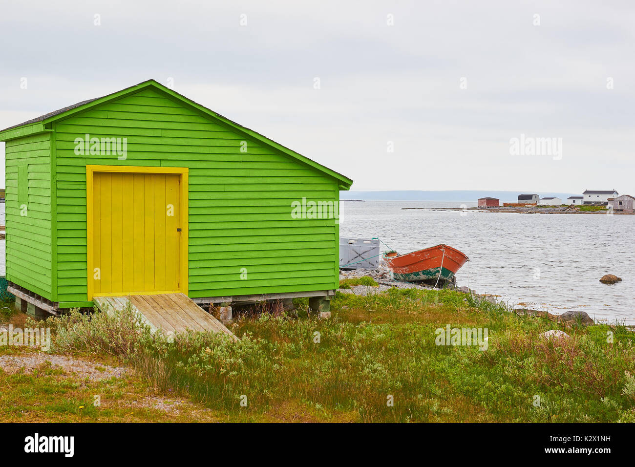 Green Timber Cabin With Yellow Door On Shores Of The Atlantic