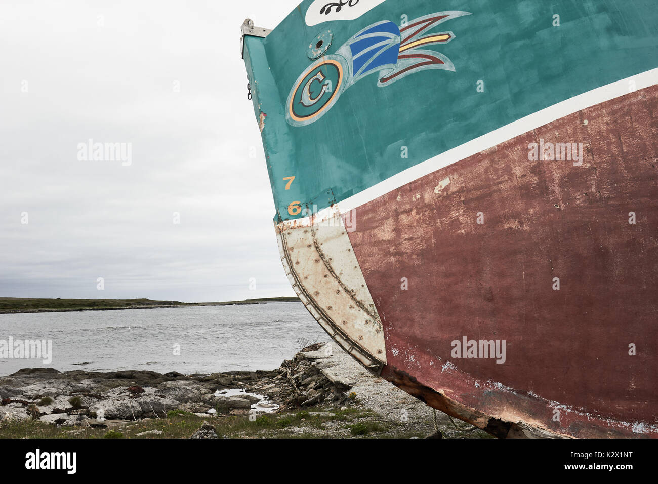 Newfoundland and Labrador flag painted on a rusting fishing trawler, Great Northern Peninsula, Newfoundland, Canada Stock Photo