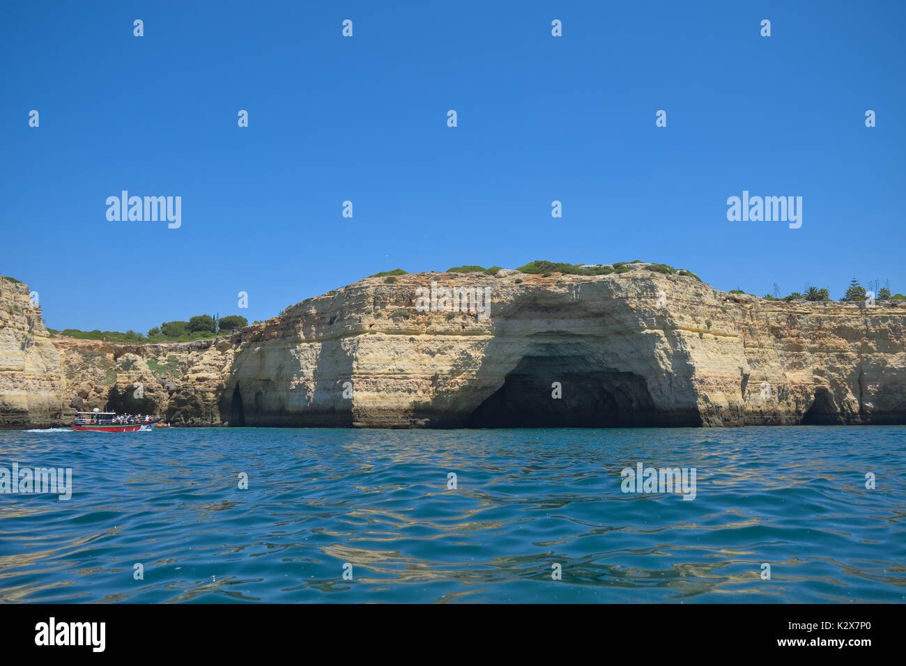 Tour boats visiting Carvoeiro caves and cliffs. Travel and vacation destinations Stock Photo