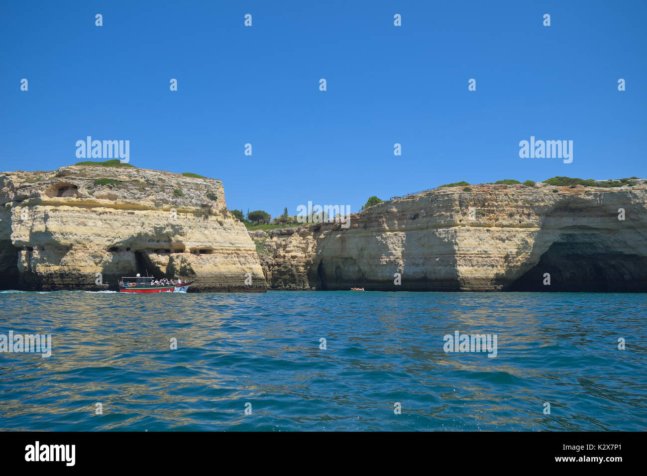 Tour boats visiting Carvoeiro caves and cliffs. Travel and vacation destinations Stock Photo