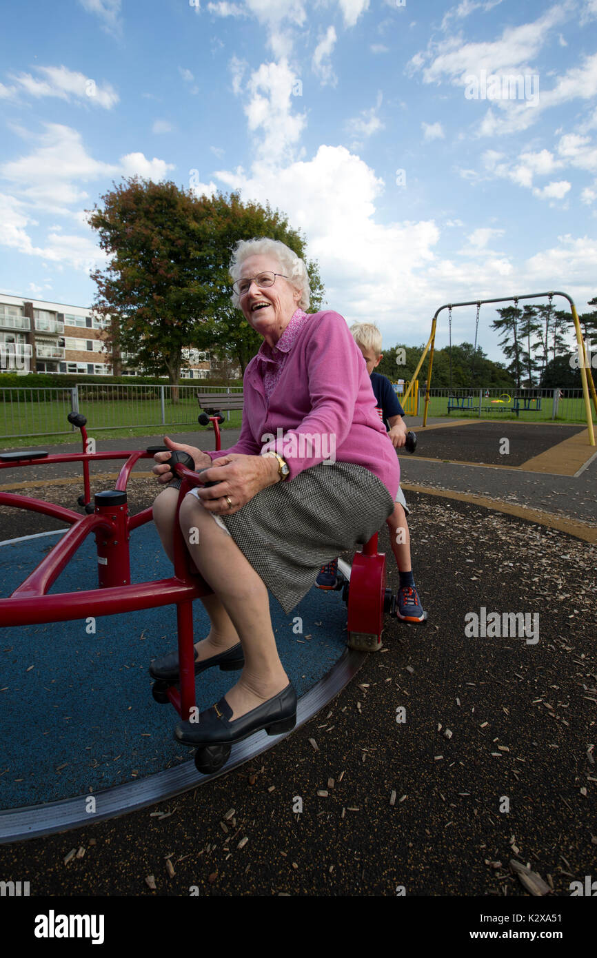 Grandmother having fun with her grandchildren at a recreational park in Southwest England, United Kingdom Stock Photo