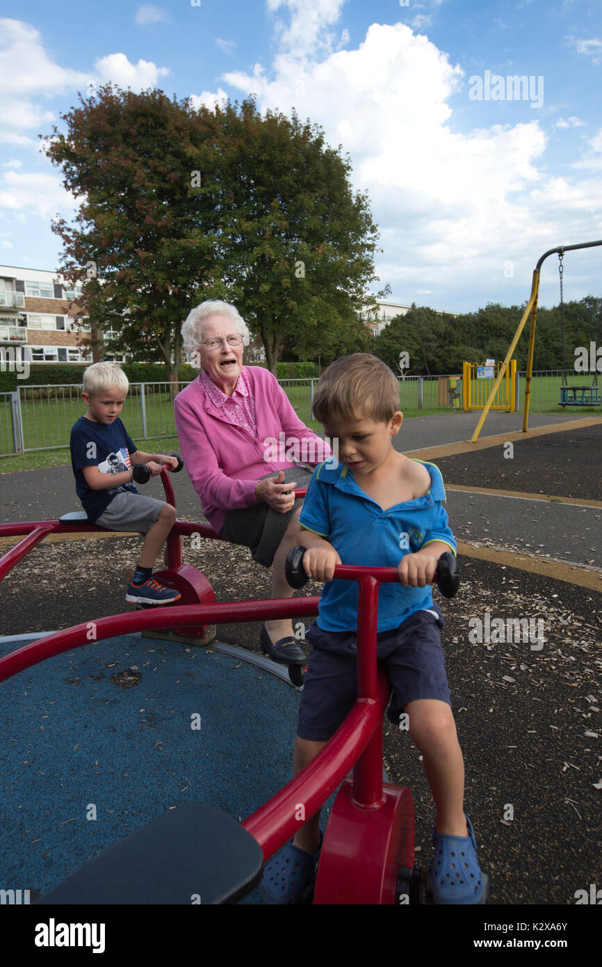 Grandmother having fun with her grandchildren at a recreational park in Southwest England, United Kingdom Stock Photo