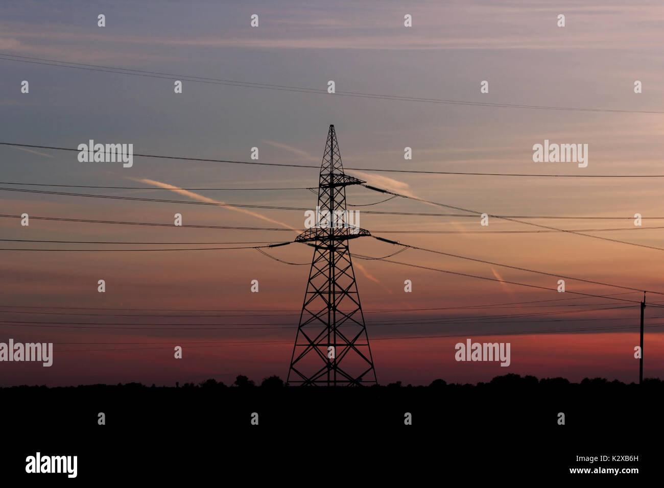 Pylon high voltage power line on sunset. Large towers of metal ...