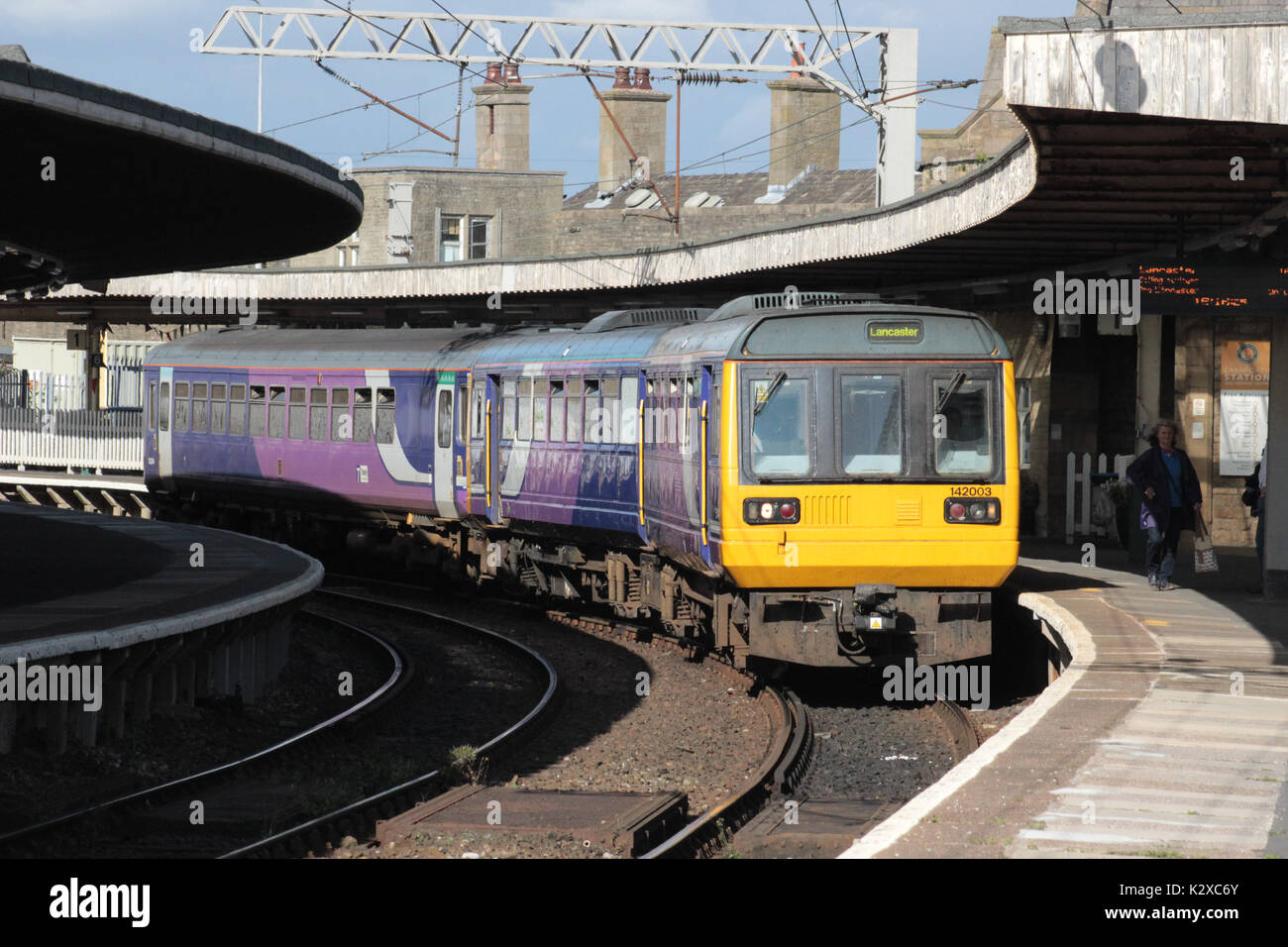 Class 142 Pacer diesel multiple unit with class 153 super sprinter passenger train in Carnforth railway station platform 1. Stock Photo