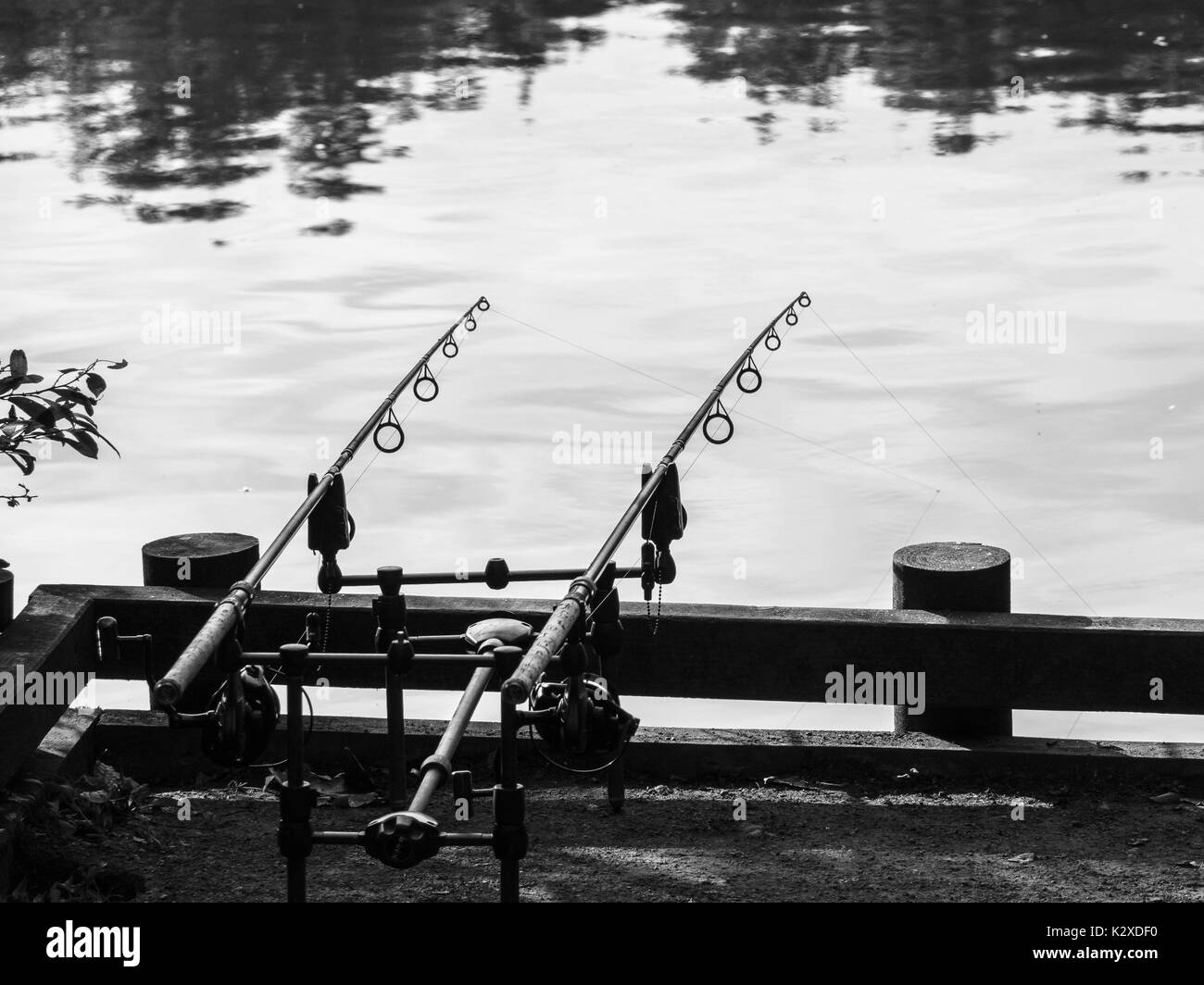 Two rods on a stand fishing in a lake Stock Photo