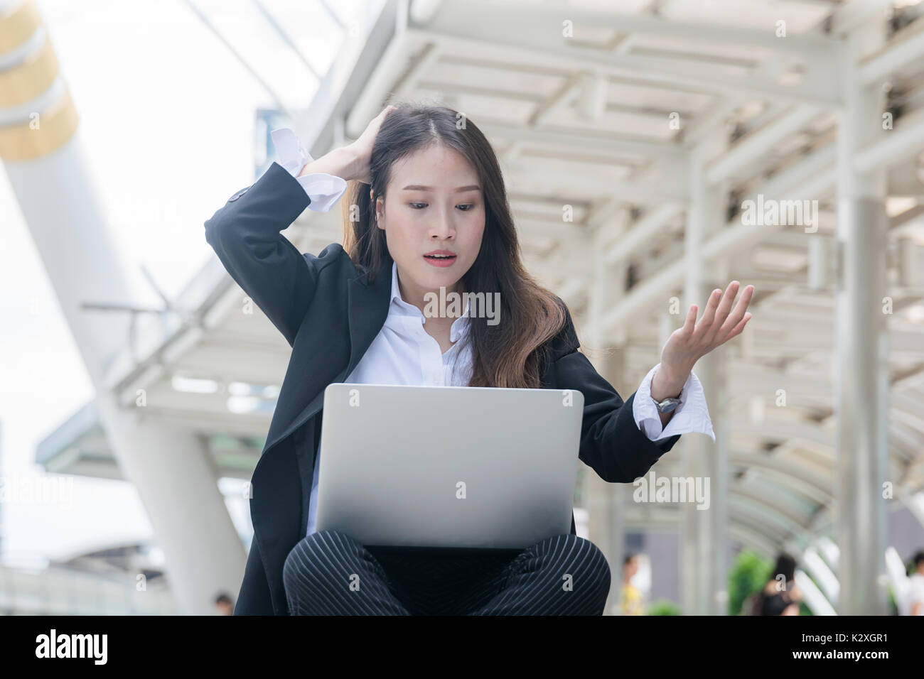 Young business woman working with laptop looking laptop notebook with shocked negative stress posture Stock Photo