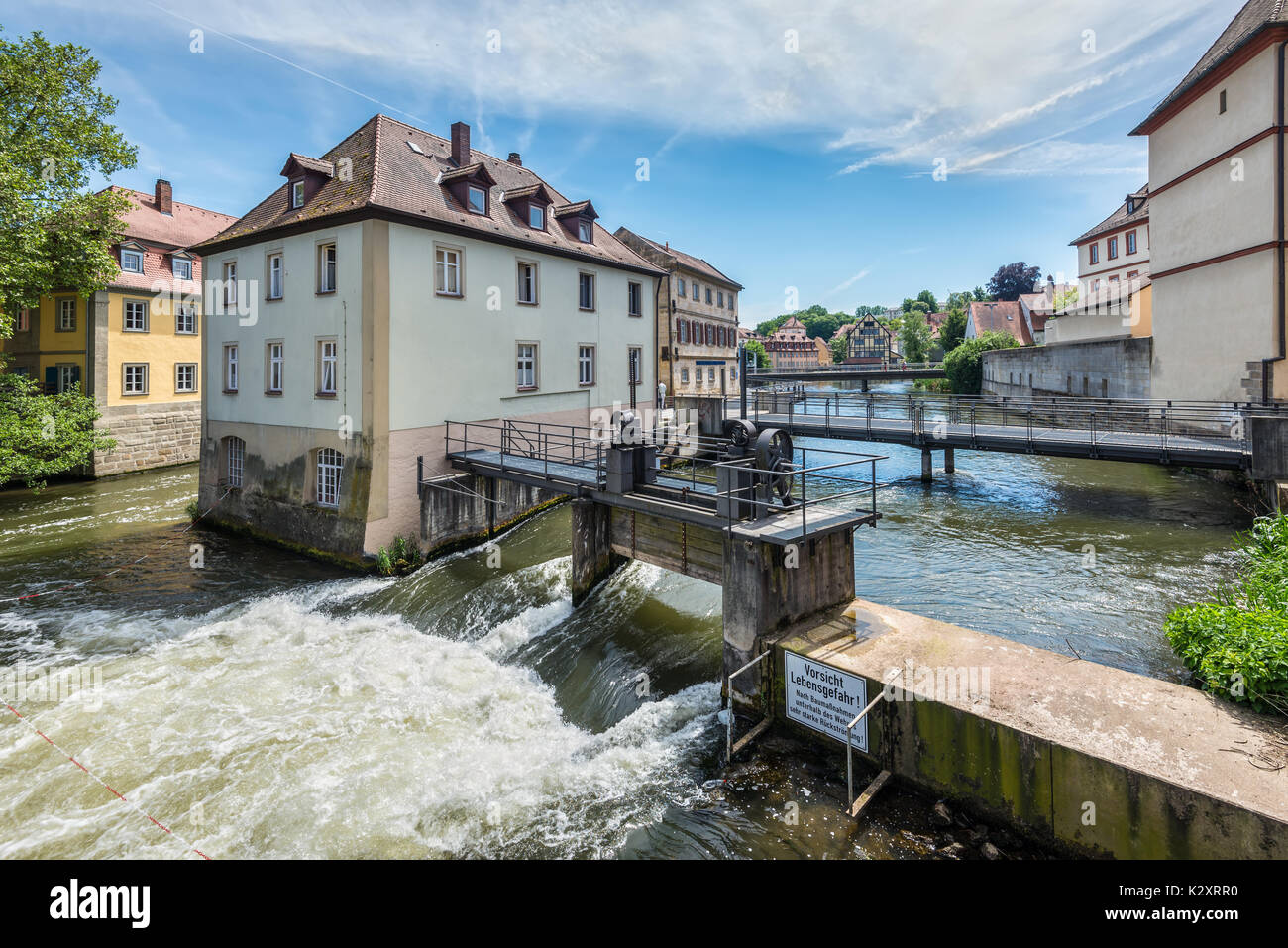 Bamberg, Germany - May 22, 2016: Dams, bridges, old houses on artificial islands and banks of the Regnitz river. Historic city center of Bamberg is a  Stock Photo