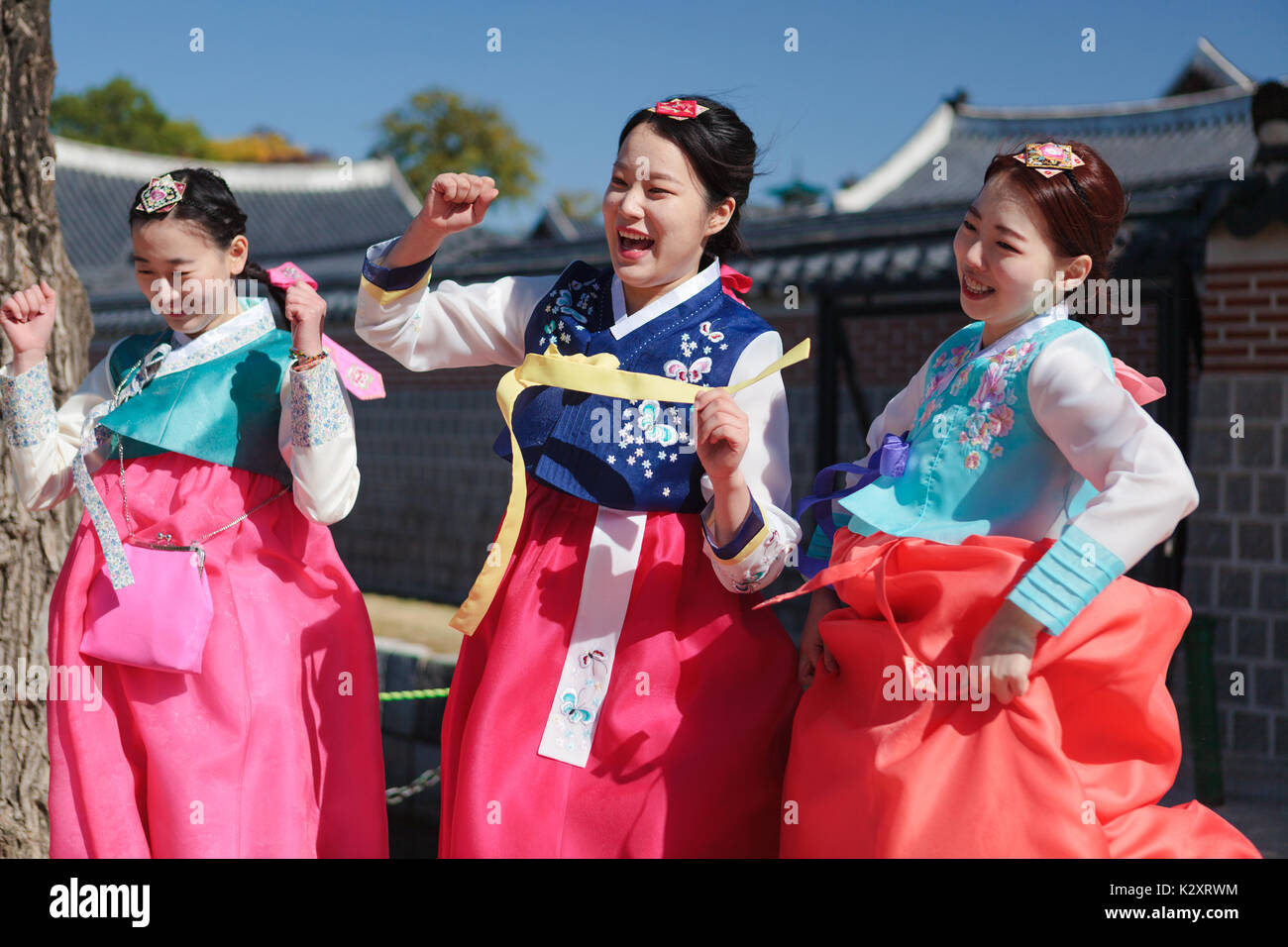 Korean young women wear national costume dance with happy faces in Gyeongbokgung palace yard, October 30, Seoul, Korea Stock Photo
