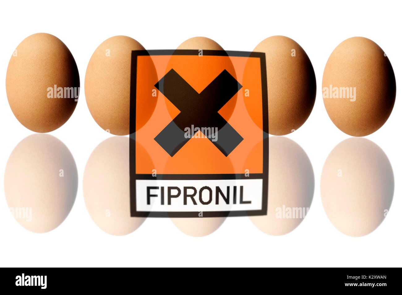 Chicken eggs with warning label, symbolic photo for Fipronil load with eggs, Huehnereier mit Warnlabel, Symbolfoto fuer Fipronil-Belastung bei Eiern Stock Photo