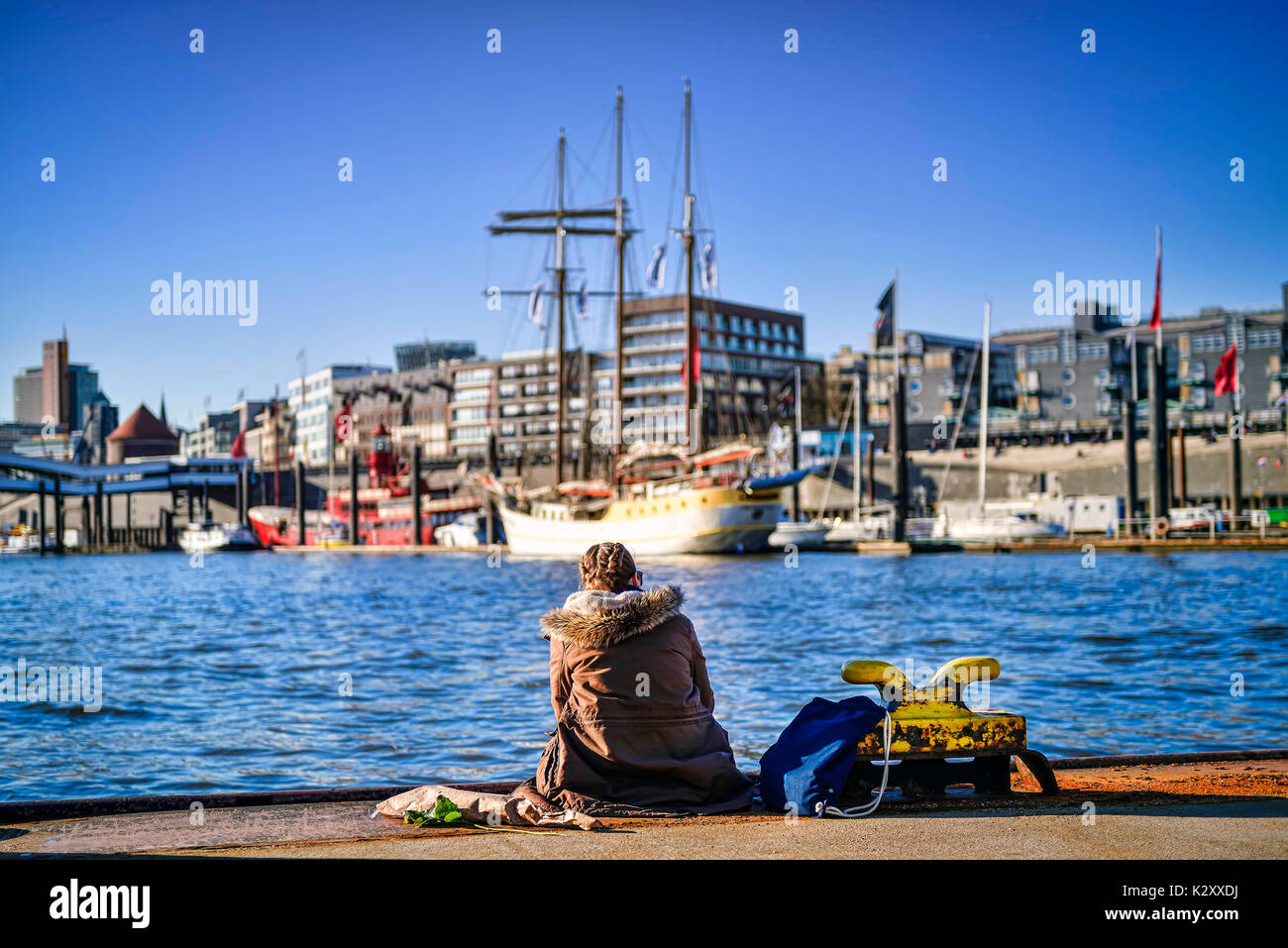 Young woman on a pontoon in the Hamburg harbour, Germany, Europe, Junge Frau auf einem Ponton im Hamburger Hafen, Deutschland, Europa Stock Photo