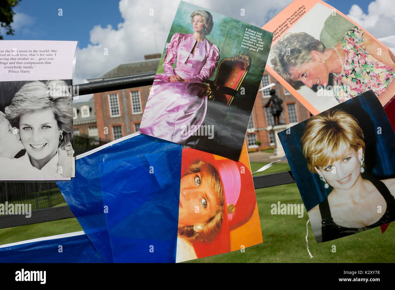 As crowds of royalist well-wishers gather, a spontaneous memorial of flowers, photos and memorabilia grows outside Kensington Palace, the royal residence of Princess Diana who died in a car crash in Paris exactly 20 years ago, on 31st August 2017, in London, England. In 1997 a sea of floral tributes also filled this area of the royal park as well as in the Mall where her funeral passed. Then, as now - a royalists mourned the People's Princess, a titled coined by the then Prime Minister Tony Blair. Stock Photo