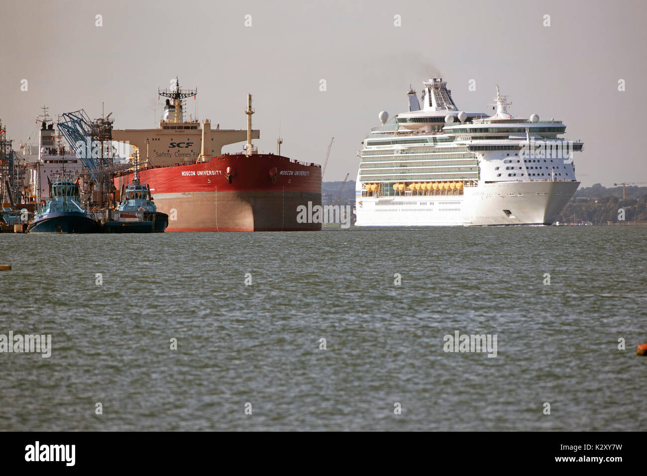 Cruise liner Navigator of the Seas passing the Russian tanker ship Moscow University alongside the Fawley Marine Terminal on Southampton Water, UK Stock Photo