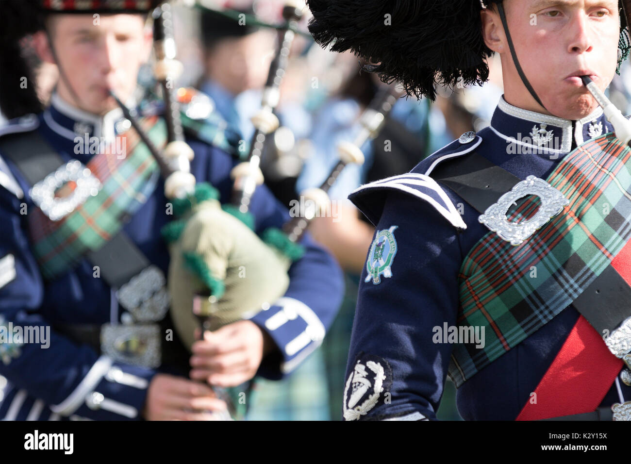 Ballater, Scotland - Aug 10, 2017: Massed Pipe Bands marching the the Highland Games event at Ballater, Scotland. Stock Photo